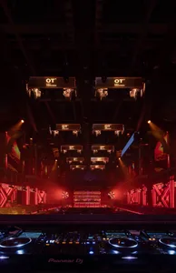 An illuminated nightclub interior featuring metal and glass architectural elements.