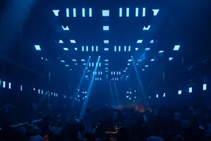 A large, industrial-style nightclub interior with metal and glass features.