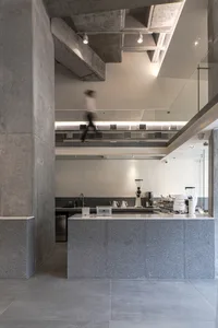 Modern coffee shop with a concrete countertop and minimalist design.