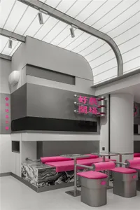 Modern restaurant interior with metallic seating, pink cushioned chairs, and glass panels.