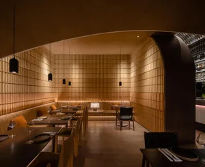 Modern wooden restaurant interior with tables, chairs, and pendant lights.