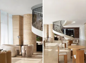 A modern hotel lobby featuring stone and concrete materials for a sophisticated and elegant atmosphere.