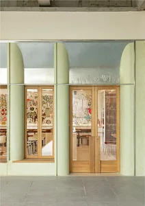 Modern restaurant shopfront featuring wooden elements and glass panels