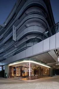 An exterior view of a modern retail storefront featuring glass and metal materials.