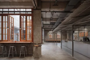 Industrial-style coffee shop interior with brick walls, concrete floors, and metal accents