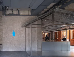 A minimalist cafe interior with a concrete finish.