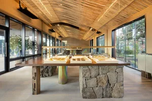 Café interior featuring stone and wooden elements, with a modern and minimalistic design.