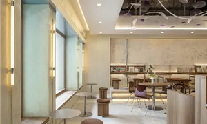 A modern cafe interior with concrete and wooden elements