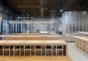 A modern coffee shop with a wood-concrete-tile interior design.