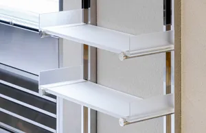 Modern interior design featuring metal and acrylic floating shelves against a textured wall