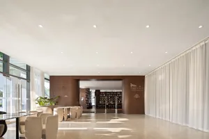 Modern library lounge featuring wood, curtains, and glass materials