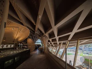 Modern restaurant interior with wooden accents and large windows