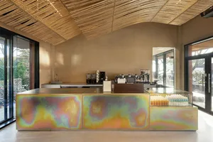 Modern coffee shop counter with a multicolored metallic design.