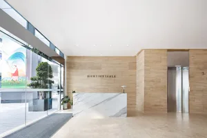 Modern office lobby featuring marble countertops and concrete walls