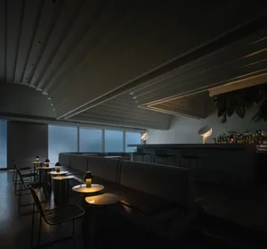 現代餐廳酒吧室內，採用混凝土材質與極簡設計。