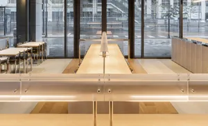 Modern restaurant interior with wooden counter and seating
