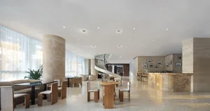 Modern hotel lobby featuring marble, wood, and glass materials.