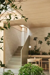 Modern, minimalist coffee shop interior with exposed concrete walls.