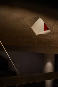 A minimalist interior with modern materials and geometric lighting design.