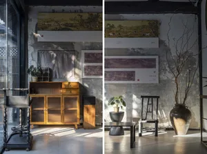 Industrial living room with concrete walls, minimalistic design, and artistic framed paintings.
