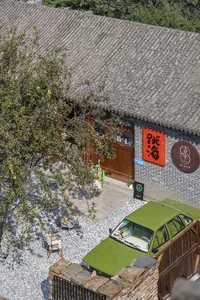 A modern retail shop with a brick exterior and gravel courtyard.