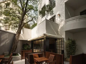 Modern residential patio with wooden furniture and plants
