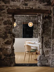 A modern restaurant interior featuring stone and concrete materials.