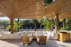 Lounge area with white cushions and wooden lattice structure
