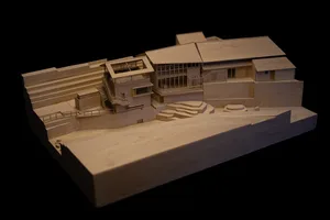 A wooden architectural model of a residential building with contemporary design features.