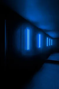 Modern minimalist interior with bright royal blue fluorescent lighting fixtures.