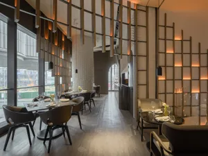 Modern restaurant interior with wooden accents and sleek furniture, featuring a contemporary design with a minimalist aesthet