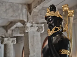 A golden sculpture with intricate details in an interior setting.