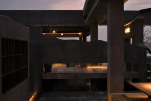 A modern architectural space featuring brick walls and warm lighting.