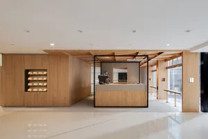 A minimalist coffee shop with wooden walls and furniture.