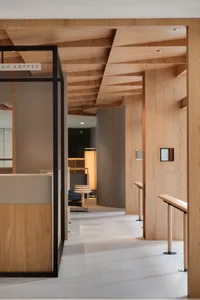 A modern coffee shop interior with wooden elements and a minimalist design.