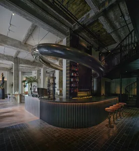 A modern bar with a metal counter and industrial design features.