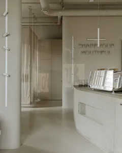 Industrial-style coffee shop interior featuring a sleek concrete counter with a coffee brewing equipment.