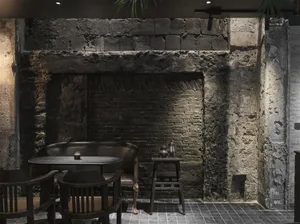Industrial-style restaurant interior with brick walls and concrete floor