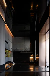 Modern hotel lobby featuring sleek, minimalist design with concrete and glass materials.