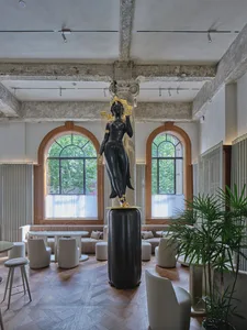 A modern interior space featuring a metallic statue