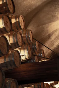 Stacked wooden wine barrels in a rendered interior space.
