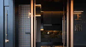 Modern restaurant entryway featuring glass, metal, and stone materials.