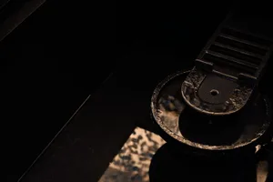 A minimalist industrial metal drain with a metallic sheen.