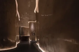 A modern interior space featuring curved concrete walls