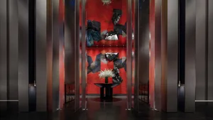 A modern hotel lobby featuring metallic texture floors and walls.