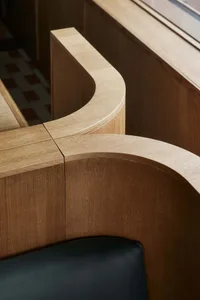 Close-up of an industrial-style office space featuring wooden furniture.