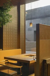 Modern restaurant interior with glass walls and hanging lamp