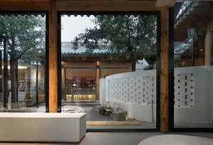 Living room with large glass walls and wooden beams