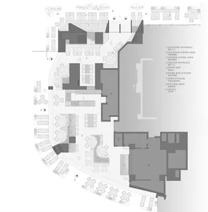 Detailed architectural blueprint of a restaurant layout showing outdoor and indoor dining areas, bar, kitchens, and office sp