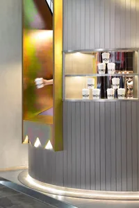 A minimalist coffee shop counter with metallic panels.